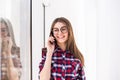 Portrait of young attractive smiling caucasian girl talking per mobile phone. Royalty Free Stock Photo