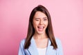 Portrait of young attractive smiling cheerful positive girl woman female wink blink eye isolated on pink color Royalty Free Stock Photo
