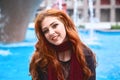 Portrait of young attractive smiling woman with long red hair dr Royalty Free Stock Photo