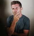 portrait of young attractive thoughtful man thinking looking pensive and doubtful as if pondering or trying to understand Royalty Free Stock Photo