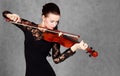 Portrait of a young attractive violinist woman in a black evening dress Royalty Free Stock Photo