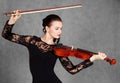 Portrait of a young attractive violinist woman in a black evening dress Royalty Free Stock Photo