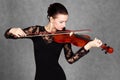 Portrait of a young attractive violinist woman in a black evening dress Royalty Free Stock Photo