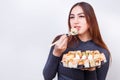 Portrait of young attractive woman eating sushi, studio shoot on Royalty Free Stock Photo