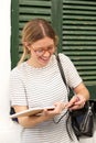 Young attractive woman with glasses looking at book Royalty Free Stock Photo