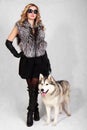 Portrait of a young attractive woman with a husky dog Royalty Free Stock Photo