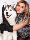 Portrait of a young attractive woman with a husky dog Royalty Free Stock Photo