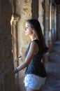 Portrait young attractive woman with look to the horizon serious standing over isolated stone wall Royalty Free Stock Photo