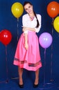 Portrait of a young attractive woman near many bright balloons Royalty Free Stock Photo