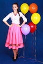 Portrait of a young attractive woman near many bright balloons Royalty Free Stock Photo