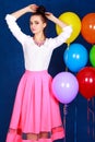 Portrait of a young attractive woman near many bright balloons Royalty Free Stock Photo