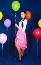 Portrait of a young attractive woman near many bright balloons Royalty Free Stock Photo