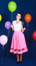 Portrait of a young attractive woman near many bright balloons Royalty Free Stock Photo