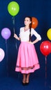 Portrait of a young attractive woman near many bright balloons Royalty Free Stock Photo