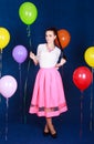 Portrait of a young attractive woman near many bright balloons Royalty Free Stock Photo