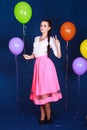 Portrait of a young attractive woman near many bright balloons Royalty Free Stock Photo