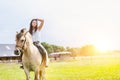 Portrait of young attractive woman riding horse in ranch Royalty Free Stock Photo