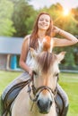 Portrait of young attractive woman riding horse in ranch Royalty Free Stock Photo