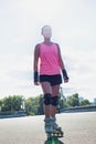 Portrait of young attractive woman wearing rollerblades