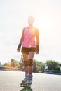 Portrait of young attractive woman wearing rollerblades