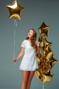 Portrait young attractive woman in white dress, holding bunch of Royalty Free Stock Photo