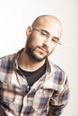 Portrait of a young bald man with a beard and glasses Royalty Free Stock Photo