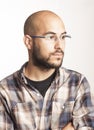 Portrait of a young bald man with a beard and glasses Royalty Free Stock Photo