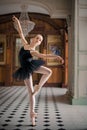 Portrait of a young ballerina on pointe shoes in a black swimsuit, tutu and pointe shoes Royalty Free Stock Photo