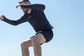 Portrait of a young bearded athlete of twenty-five, jumping against a blue sky. Royalty Free Stock Photo