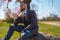 Portrait of a young bearded guy with closed eyes, from whose head a tree grows. on open air. In creative artistic toning. Business