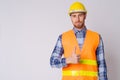 Portrait of young bearded man construction worker giving thumbs up Royalty Free Stock Photo