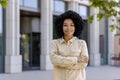 Portrait of a young beautiful African American businesswoman outside an office building, the woman is smiling and Royalty Free Stock Photo