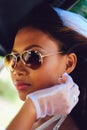 Portrait of a young beautiful Asian bride with sunglasses on her wedding day