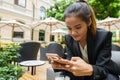 Young beautiful Asian businesswoman using phone at the coffee shop Royalty Free Stock Photo