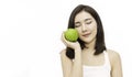 Portrait of young beautiful asian girl with hands holding green and red apple. Royalty Free Stock Photo