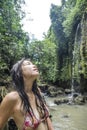 Portrait of young beautiful Asian girl looking pure and enjoying nature beauty with face wet under amazing beautiful natural water Royalty Free Stock Photo