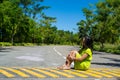 Portrait of young beautiful asian girl sitting on the road looking at side Royalty Free Stock Photo