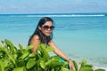 Portrait of young beautiful asian girl sitting on tropical beach Royalty Free Stock Photo