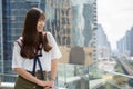 Happy young beautiful Asian teenage girl thinking against view of the city Royalty Free Stock Photo