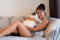 Happy young beautiful Asian woman hugging Persian cat at home Royalty Free Stock Photo