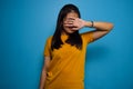 Portrait of Young beautiful asian women wearing yellow shirt with blue isolated background Royalty Free Stock Photo