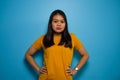 Portrait of Young beautiful asian women wearing yellow shirt with blue isolated background Royalty Free Stock Photo