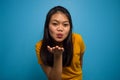 Portrait of Young beautiful asian women wearing yellow shirt with blue isolated background Royalty Free Stock Photo