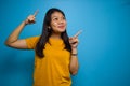 Portrait of Young beautiful asian women wearing yellow shirt with blue isolated background Royalty Free Stock Photo