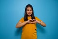 Portrait of Young beautiful asian women wearing yellow shirt with blue isolated background Royalty Free Stock Photo