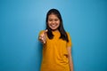 Portrait of Young beautiful asian women wearing yellow shirt with blue isolated background Royalty Free Stock Photo