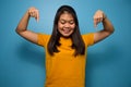 Portrait of Young beautiful asian women wearing yellow shirt with blue isolated background Royalty Free Stock Photo
