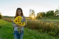 Happy young beautiful Asian woman holding sunflowers in the field Royalty Free Stock Photo