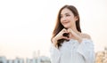 Portrait of young beautiful asian woman hands gesture in heart shape on city sky roof top. Royalty Free Stock Photo