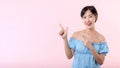 Portrait young beautiful asian woman happy smile pointing finger and hand to showing on copy space isolated on pink background. Royalty Free Stock Photo